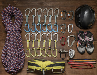 Clombing equipment lying on a wooden floor.