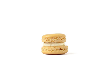 Tasty yellow macaron isolated on white