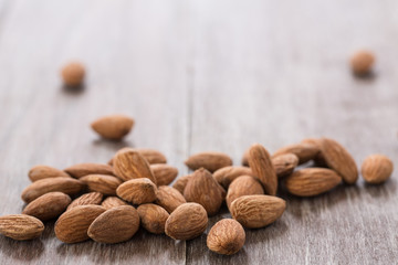 Almonds Scattered on Wood Background