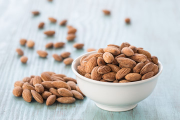 Almonds In White Bowl on Blue Wood Background