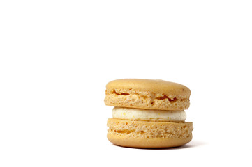 Tasty yellow macaron isolated on white
