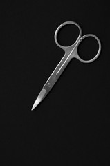 Scissors for manicure woman nails on a black background. tools