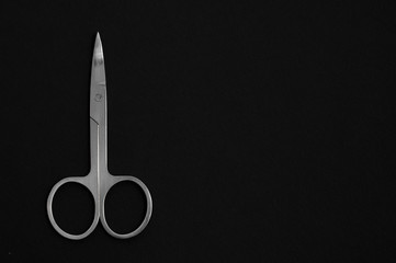 Scissors for manicure woman nails on a black background. tools