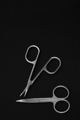 Scissors for manicure woman nails on a black background. tools