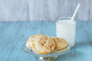 Apple Hand Pies On Antique Glass Plate With Milk