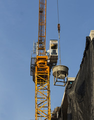 Tower crane lift cement bucket up to top of building