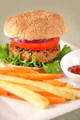 A back bean and couscous (vegan) hamburger with parsnip and sweet potato fries.
