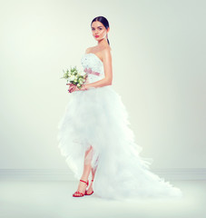 Beauty fashion young model bride in wedding dress with long train