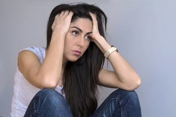 sad worried woman in thoughts at home
