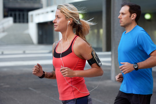 Fit active friends running together in the city