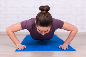 young slim woman doing plank exercise
