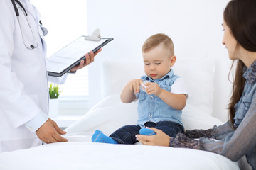 Little boy child  with his mother  at  health exam at doctor's office.