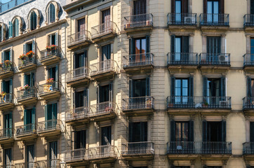 Geometric shapes of facade of modernist residential building with french balconies in Barcelona, Spain.