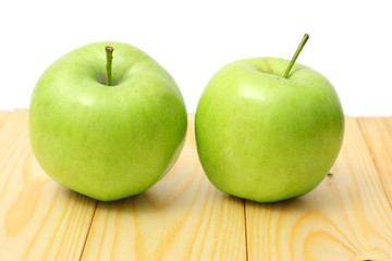Green apple on wood background