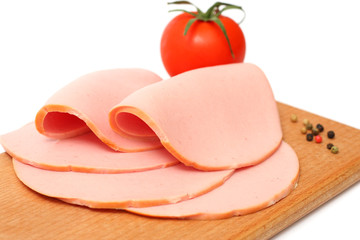 Sliced boiled ham sausage isolated on white background © Tatiana