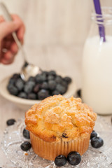 Blueberry Muffin Breakfast With Hand Spooning Blueberries