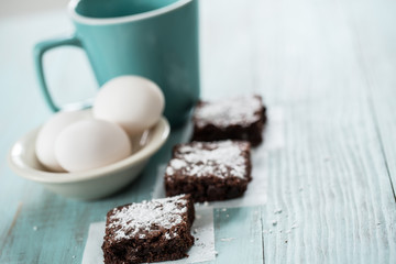 Brownies with Powdered Sugar With Eggs and Coffee Mug Room For Text