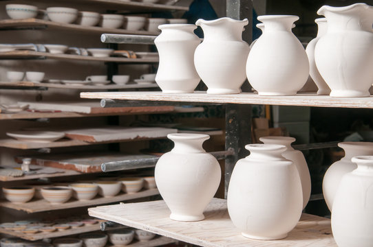 Just enamelled vases ready to be painted in the workshop of a pottery artisan in Caltagirone