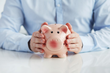 Man with piggy bank on the table