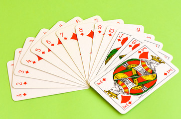 Play cards. All the diamonds - caros - isolated on green background.