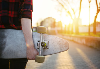 Rear view of skateboard girl holding skateboard