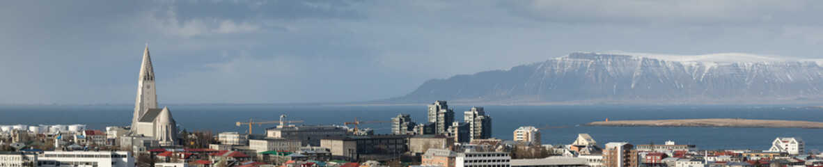 Panorama of Reykjavik skyline showing Hallgrimskirkja church cathedral and the mountains in the...