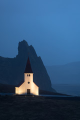 Vik i Myrdal Church in Iceland with mountain in the background taken at dusk. © L Galbraith