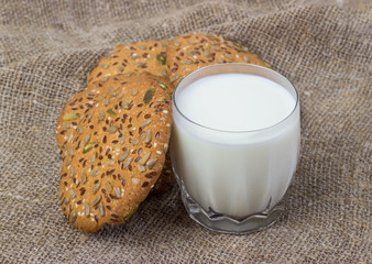 A glass of milk and cookies .