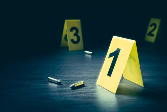 Crime Scene With Evidence Markers On A Dark Background