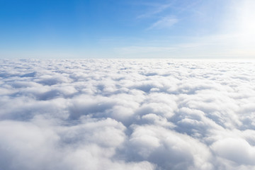 View from airplane window above the clouds