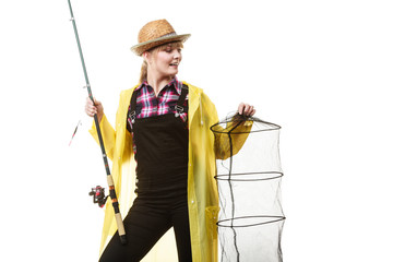 Happy woman holding fishing rod and keepnet