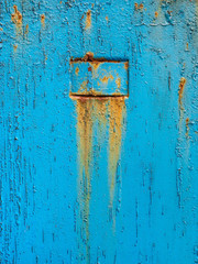 Abstract blue texture with grunge cracks. Cracked paint on a metal surface. Bright urban background with rough paint transitions. The cracks grunge urban background.