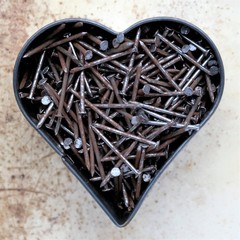 Heart shape filled with rusted nails, with a light background, Father's Day, top view