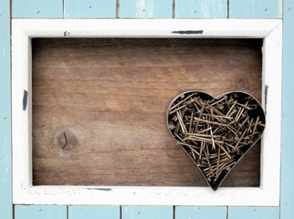 light blue and white frame, inside a heart filled with rusted nails and a natural wood background, Father's Day, Valentine, or invitation 