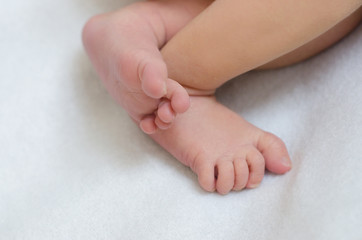 Little legs of a newborn baby boy