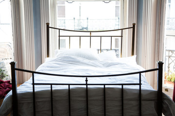 Antique brass bed with white cotton bed linen