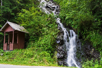 Waterfall on mountain river in Carpathian Mountains , Romania