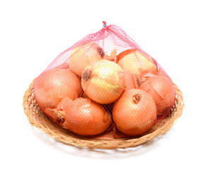 white onions or shallots in wicker basket isolated on white background