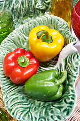 Bell peppers on plate on green cabbage leaf