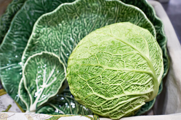 Fototapeta premium Cabbage and dish in form of green leaf