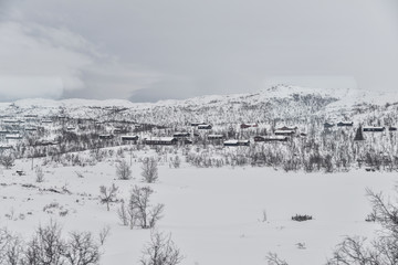 Small snow covered houses in the norwegian mountains 