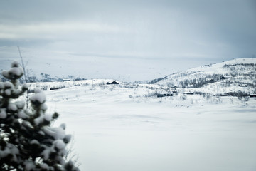 Fototapeta na wymiar Snowy norwegian mountains in the winter