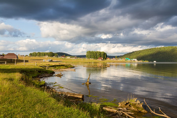 Obraz premium The village by the pond.