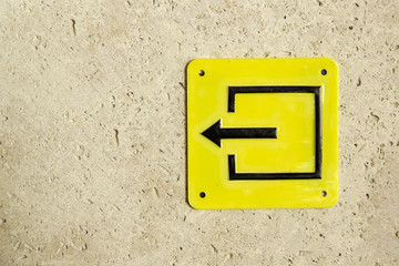 Yellow sign evacuation pointer exit left