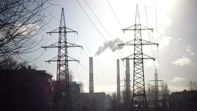 Industrial landscape. power line and smoke from pipes of combined heat and power plant