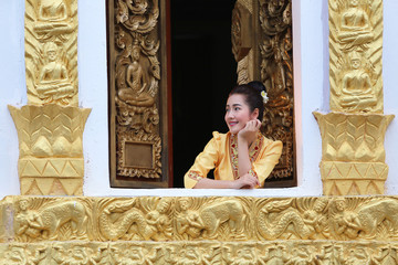 Beautiful laos woman on the Buddhist church Smiling she happiness  in luang prabang laos