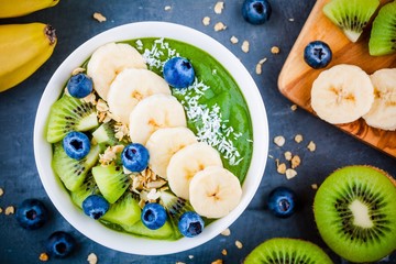 Green smoothie bowl with banana, kiwi, blueberry, granola