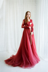 bride in an red gown with calla flower in hands