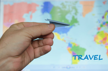 paper airplane on a background map of the world