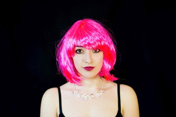 Beauty Woman With Pink Wig  over Black Background